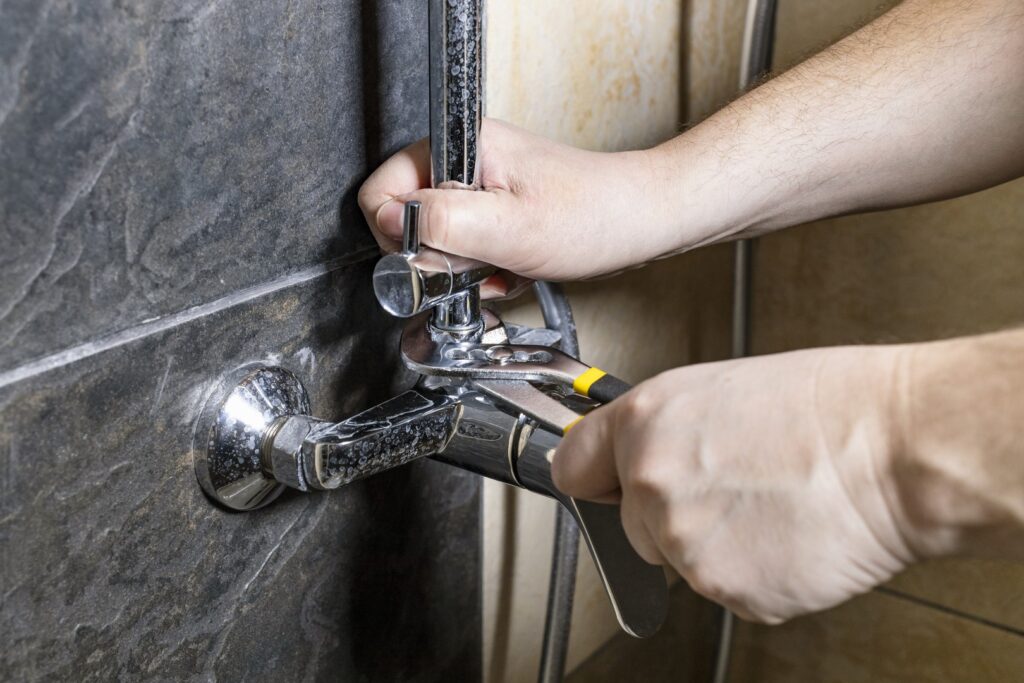 plumber-fixing-a-faucet-with-wrench
