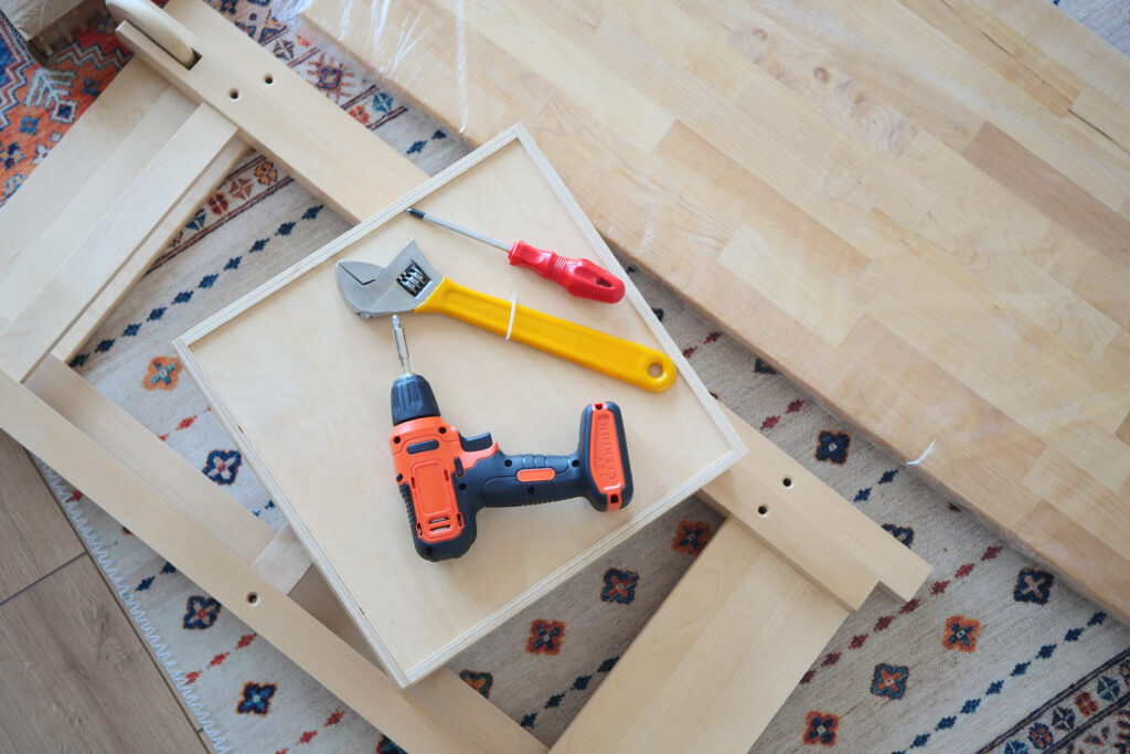 An electric screwdriver is on the floor,