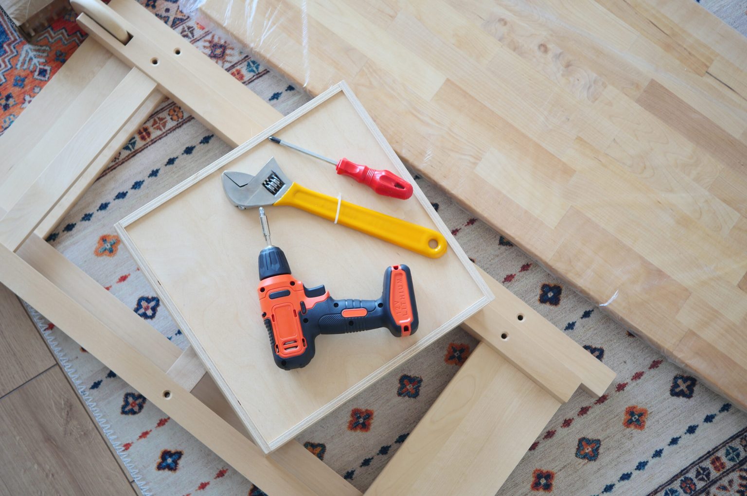An electric screwdriver is on the floor,
